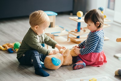 Cute,Little,Girl,And,Boy,Playing,With,Toys,By,The